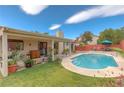 Inviting backyard oasis with a sparkling pool and relaxing patio area at 7200 Big Rock Cir, Las Vegas, NV 89129