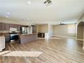 Open kitchen with island, stainless steel appliances, and hardwood floors at 773 Valley Rise Dr, Henderson, NV 89052