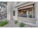 A ground floor patio with metal railing, tan canvas awning, and desert landscaping at 8250 N Grand Canyon Dr # 1040, Las Vegas, NV 89166