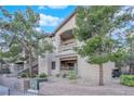 Exterior view of the building with patios and desert landscaping with beautiful, mature trees at 8250 N Grand Canyon Dr # 1040, Las Vegas, NV 89166