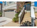 Front entry with stairs leading to the house and attached garage at 8449 Kettledrum St, Las Vegas, NV 89139