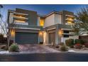 Contemporary two-story home with a three-car garage, enhanced by modern architecture and desert landscaping at 8560 Foundry Branch Ln, Las Vegas, NV 89113