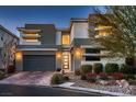 Modern two-story home with stylish architecture, lush landscaping, and a welcoming front entrance at 8560 Foundry Branch Ln, Las Vegas, NV 89113