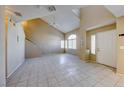 Spacious living room with high ceilings, clerestory windows, neutral paint, and tile floors at 928 Allure Dr, Las Vegas, NV 89128