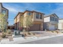 Two-story home with a paved driveway, two-car garage, and low maintenance landscaping at 10089 Bismuth St, Las Vegas, NV 89183