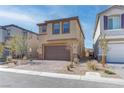 Two-story home with a paved driveway, two-car garage, and low maintenance landscaping at 10089 Bismuth St, Las Vegas, NV 89183