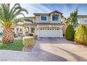 Charming two-story home with a well-maintained front yard and a brick paved driveway at 11009 Pentland Downs St, Las Vegas, NV 89141