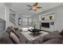 Virtually staged living room featuring a comfortable seating area, modern decor, and a ceiling fan at 11009 Pentland Downs St, Las Vegas, NV 89141