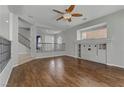Upstairs loft with hardwood flooring, staircase, and a built-in entertainment center at 11009 Pentland Downs St, Las Vegas, NV 89141