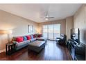 Cozy living room with a comfortable sectional sofa, modern ceiling fan, and beautiful hardwood floors at 150 Las Vegas Blvd # 803, Las Vegas, NV 89101