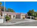 A well-maintained single-story residence featuring desert landscaping and an attached two-car garage at 2414 Inlet Beach Ct, North Las Vegas, NV 89031