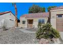 Inviting single-story home with desert landscaping, tiled roof, and a cozy front entrance at 2414 Inlet Beach Ct, North Las Vegas, NV 89031