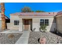 Attractive single-story home featuring desert landscaping and a welcoming front porch at 2414 Inlet Beach Ct, North Las Vegas, NV 89031