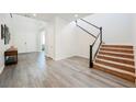 Inviting foyer featuring wood-look flooring, staircase and high ceiling at 2795 Athens Ridge Dr, Henderson, NV 89052