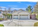 Home exterior showcasing a wide driveway and two-car garage with decorative windows at 3017 Lenoir St, Las Vegas, NV 89135