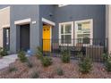 This modern townhome features a private, fenced in front porch and desert landscaping at 332 Pacific Sparrow Ave, Henderson, NV 89011