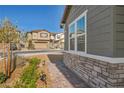 Well-maintained single-story home featuring stone accents, complemented by a walkway and garden at 3491 Argiento Ave, Henderson, NV 89044
