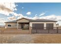 Charming single-story home showcasing a metal fence, desert landscaping, and a three-car garage at 3520 Malibou Ave, Pahrump, NV 89048