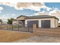 Beautiful single-story home featuring a modern fence, desert landscaping, and a three-car garage at 3520 Malibou Ave, Pahrump, NV 89048