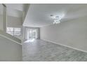 Spacious living room with tiled floors, modern light fixture, and a sliding glass door at 6250 W Flamingo Rd # 43, Las Vegas, NV 89103