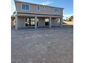 The backyard features a covered patio and an unfinished landscape at 7142 Twilight Rider Ct, Las Vegas, NV 89118
