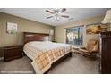 Cozy bedroom with a ceiling fan and a comfortable seating area at 870 Santa Maria Way, Mesquite, NV 89027