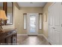 Bright foyer features a decorative glass front door and neutral tile flooring at 870 Santa Maria Way, Mesquite, NV 89027