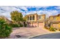 Beautiful two-story home featuring a three-car garage and lovely landscaping at 12118 La Carta Ct, Las Vegas, NV 89138