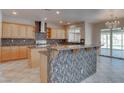 Charming kitchen features an island with bar seating and sliding glass doors at 1534 Waterford Falls Ave, Las Vegas, NV 89123