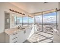 Bathroom featuring double sink vanity, modern lighting, and expansive windows with panoramic city views at 200 W Sahara Ave # 2108, Las Vegas, NV 89102