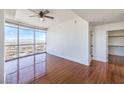 Bright bedroom with hardwood floors, large windows showcasing panoramic city views, and a walk-in closet at 200 W Sahara Ave # 2108, Las Vegas, NV 89102