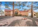 Charming single-story home with a red tile roof and low-maintenance desert landscaping at 2612 Springridge Dr, Las Vegas, NV 89134