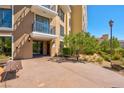 Inviting condo building entrance featuring well-maintained landscaping and comfortable seating at 29 Montelago Blvd # 205, Henderson, NV 89011