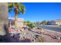 Street view of a residential neighborhood with palm trees and well-maintained homes at 3157 Faiss Dr, Las Vegas, NV 89134