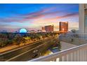 Balcony view of the city with a vibrant sunset and prominent buildings at 360 E Desert Inn Rd # 602, Las Vegas, NV 89109