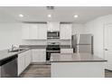 Modern kitchen featuring stainless steel appliances, white cabinetry, and a center island at 4203 Gold Desert St, North Las Vegas, NV 89032