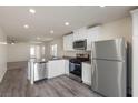 Modern kitchen featuring stainless steel appliances, white cabinetry, and ample counter space at 4215 Gold Desert St, North Las Vegas, NV 89032