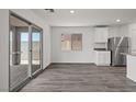 Dining area with wood floors and sliding glass doors leading to the outdoor space at 4223 Gold Desert St, North Las Vegas, NV 89032