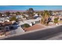 An elevated shot showing a nice single-story home nestled in a desert neighborhood near distant mountains at 4312 Alpine Pl, Las Vegas, NV 89107