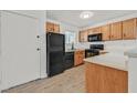 Functional kitchen featuring wooden cabinets, laminate countertops, and modern black appliances at 5394 Swenson St # 29, Las Vegas, NV 89119