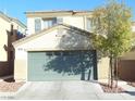 Two-story home featuring a spacious two-car garage, neutral stucco and trim, and low-maintenance landscaping at 5490 Floating Flower Ave, Las Vegas, NV 89139