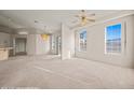 Spacious living room with large windows, neutral carpet and paint, and open floor plan at 701 Aztec Cir, Mesquite, NV 89027