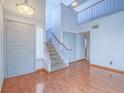 Bright entryway features staircase to second floor and hardwood floors at 7117 Shadow Crest Dr, Las Vegas, NV 89119