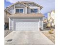 Two-story home featuring an attached two-car garage and desert landscaping at 7117 Shadow Crest Dr, Las Vegas, NV 89119