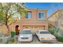 Charming two-story home with a two-car garage and desert landscaping, with two cars parked outside at 7433 Calzado Dr, Las Vegas, NV 89178