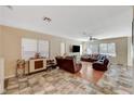 Large living room with wood-look flooring, and a comfortable sectional sofa at 7433 Calzado Dr, Las Vegas, NV 89178