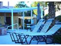 Community pool area with lounge chairs and covered seating at 7950 W Flamingo Rd # 1139, Las Vegas, NV 89147