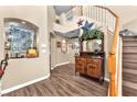 Elegant entryway featuring hardwood floors, decorative console table, and staircase at 8404 Bay Crest Dr, Las Vegas, NV 89128