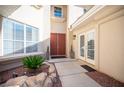 Inviting front entrance featuring a double-door entry, decorative stone accents, and manicured plants at 204 N Ring Dove Dr, Las Vegas, NV 89144