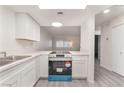 Renovated kitchen with white cabinets, new appliances, and spacious countertops at 228 N Bruce St # D, Las Vegas, NV 89101